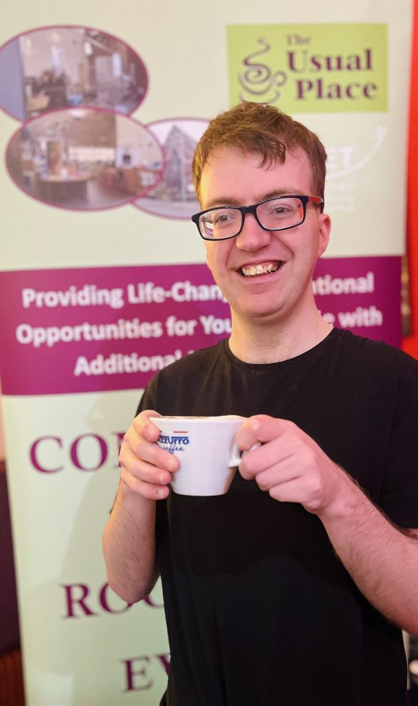 Smiling man holding cup of tea