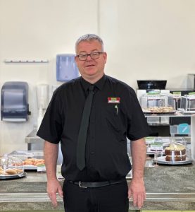 Man standing in front of cafe counter